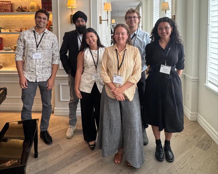 students standing together in a meeting room