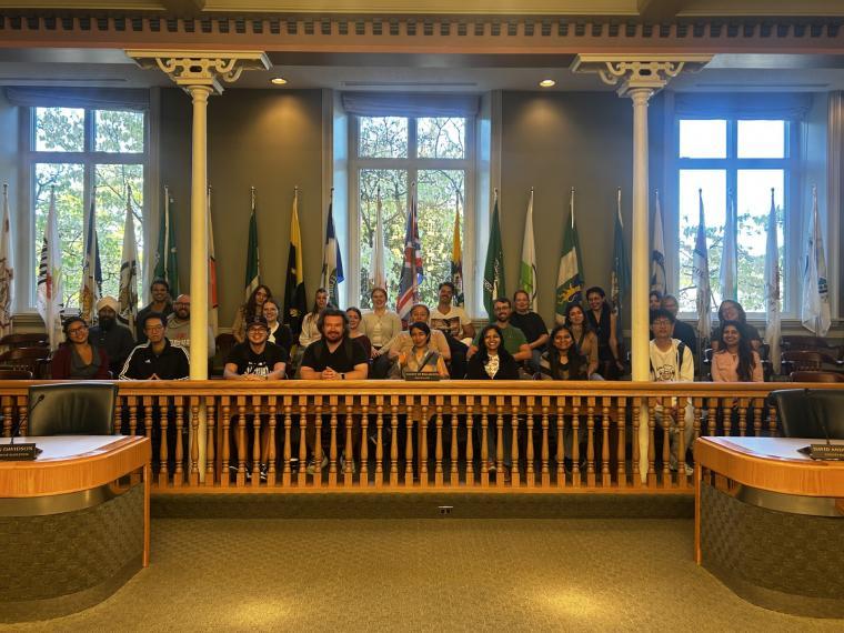Students sitting together in the Wellington County administrative chambers