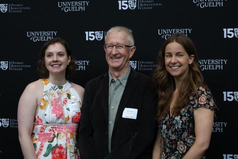 Two students standing with Dr. Wayne Caldwell