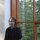 James Tuer in front of large windows