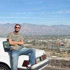 Jeff Brown sitting on car trunk