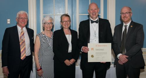 Robert Brown receiving award from four CSLA members