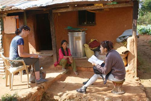 Ashley  Honsberger conducting an interview with a farmer with the help of her translator.