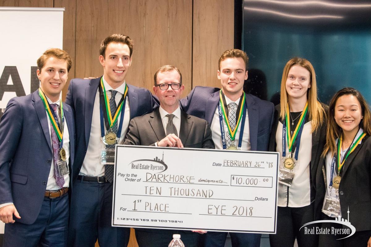 Five students holding award cheque