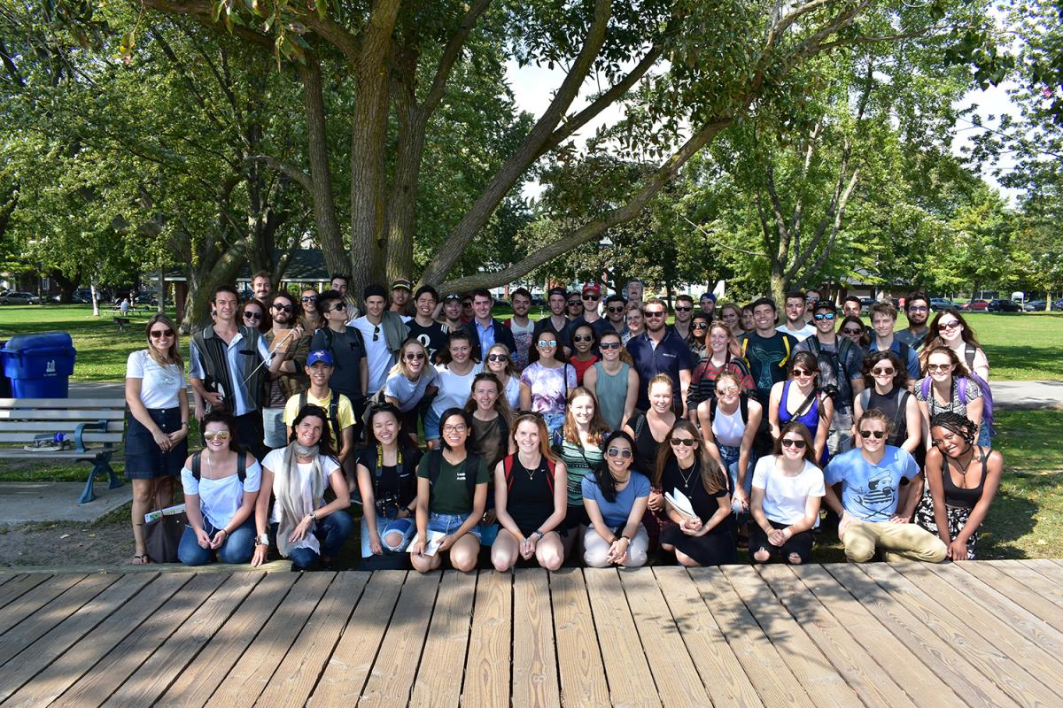 Group photo of students in front of boardwalk at Toronto Beach