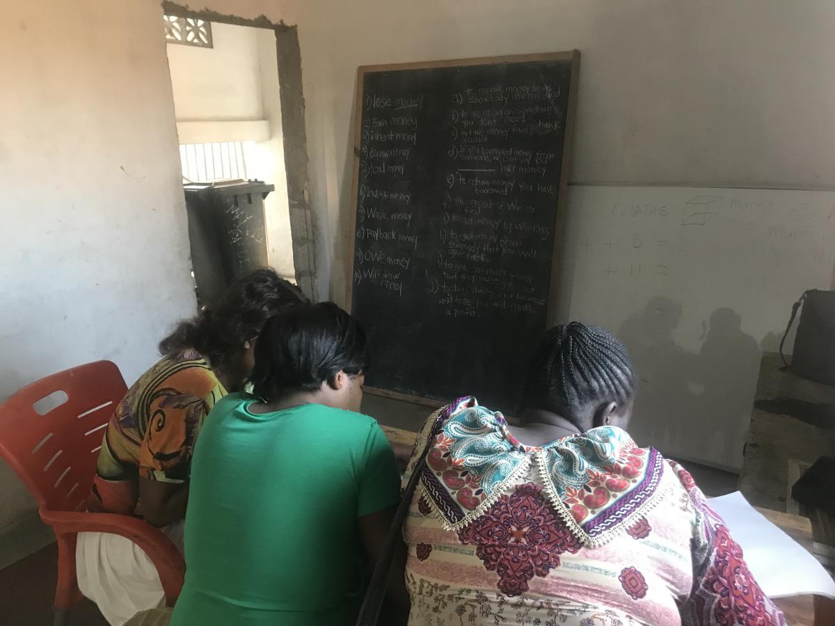 Three women sitting down for class