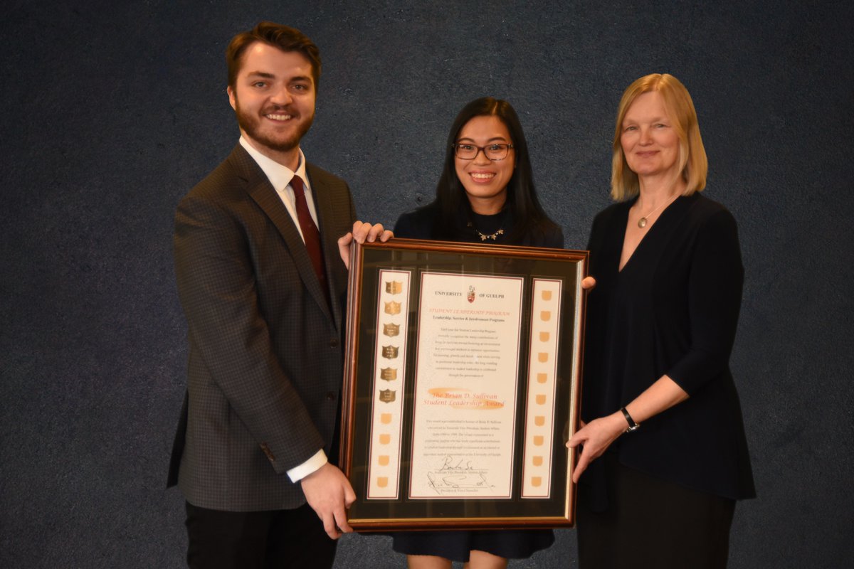 Jenny Trinh receiving award from Joshua White and Karen Landman