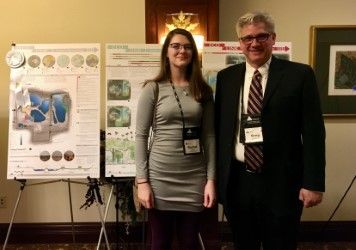 Student standing in front of OSSGA design panels