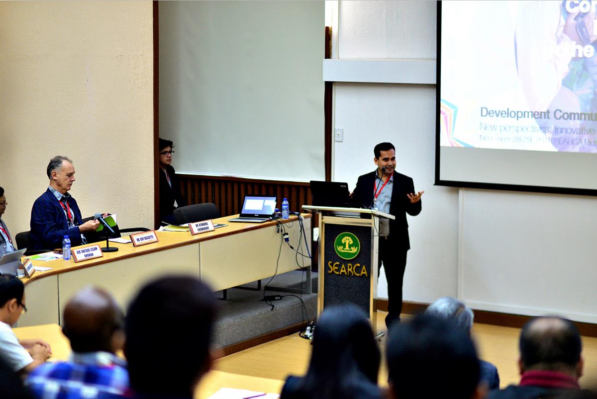 Dr. Chowdury standing behind podium speaking to a crowd of people