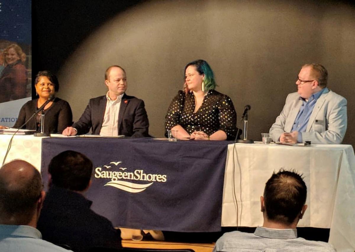 Four people behind desk for guest panel discussion at Saugeen Shores