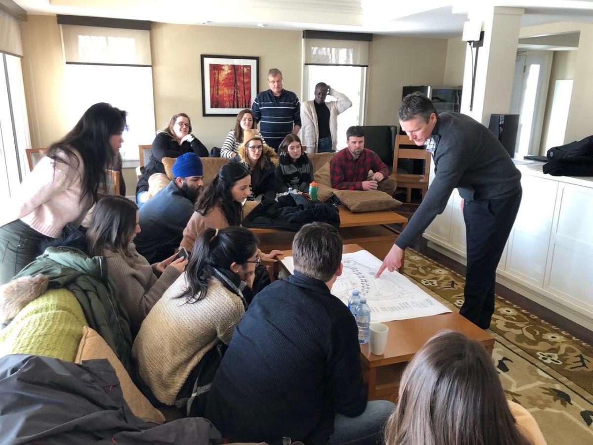 students sitting on couches viewing map