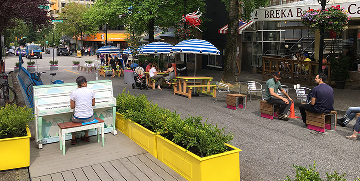 People using parklet space on city street