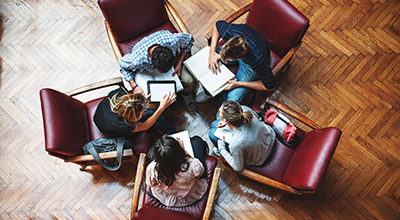 Aeriel view of five students sitting in a circle