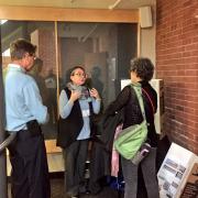 Verena Kulak (centre) explaining research to two conference attendees