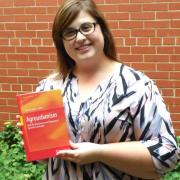 Sara Epp holding Agrourbanism book