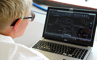 student working in AutoCad on laptop