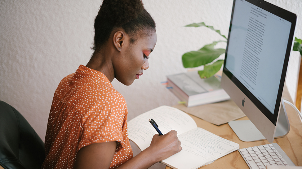 student taking her classes online in front of her computer