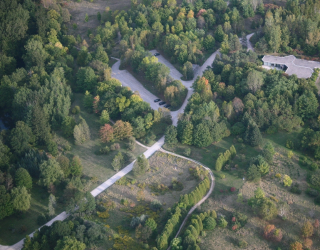 Arial view of the Arboretum at the University of Guelph in September. Mostly green trees, but some are beginning to change colour. 